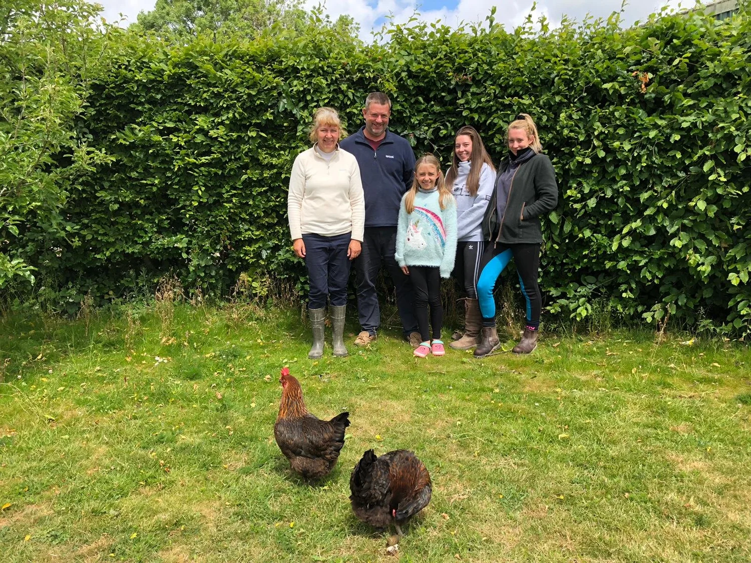 Iain, Jane and their daughters in the garden at Berryfields